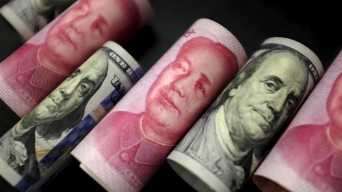 Đồng NDT của Trung Quốc và USD của Mỹ. Ảnh: Reuters