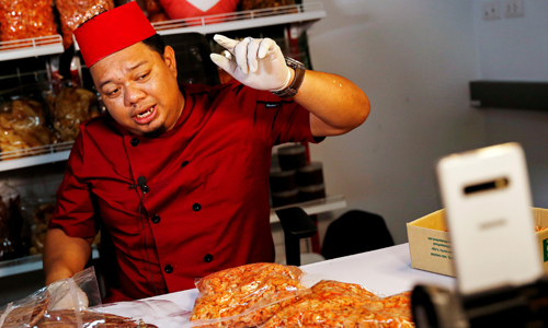 Anurak Saruethai đang giới thiệu sản phẩm qua Facebook. Ảnh: Reuters