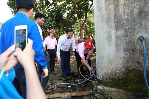 Đại diện chính quyền cùng ông Montri Suwanposri (đội nón đỏ) - Tổng Giám đốc CP Việt Nam kiểm tra nước dẫn về làng.