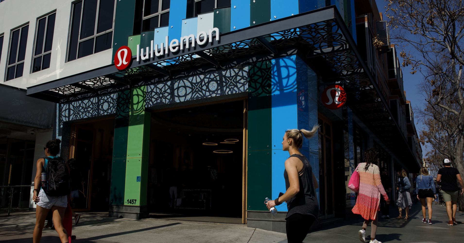 A woman jogs past a Lululemon retail store.