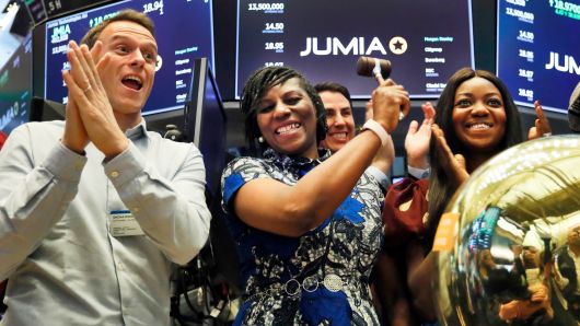 Jumia co-CEO Sacha Poignonnec, left, applauds as Jumia Nigeria CEO Juliet Anammah, center, rings a ceremonial bell when the company