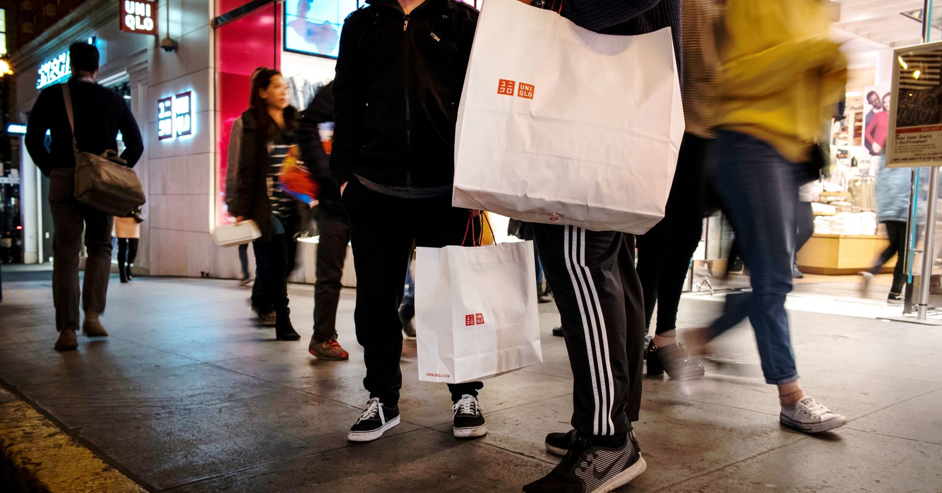Shoppers hold Uniqlo bags in San Francisco, California, January 3, 2019.