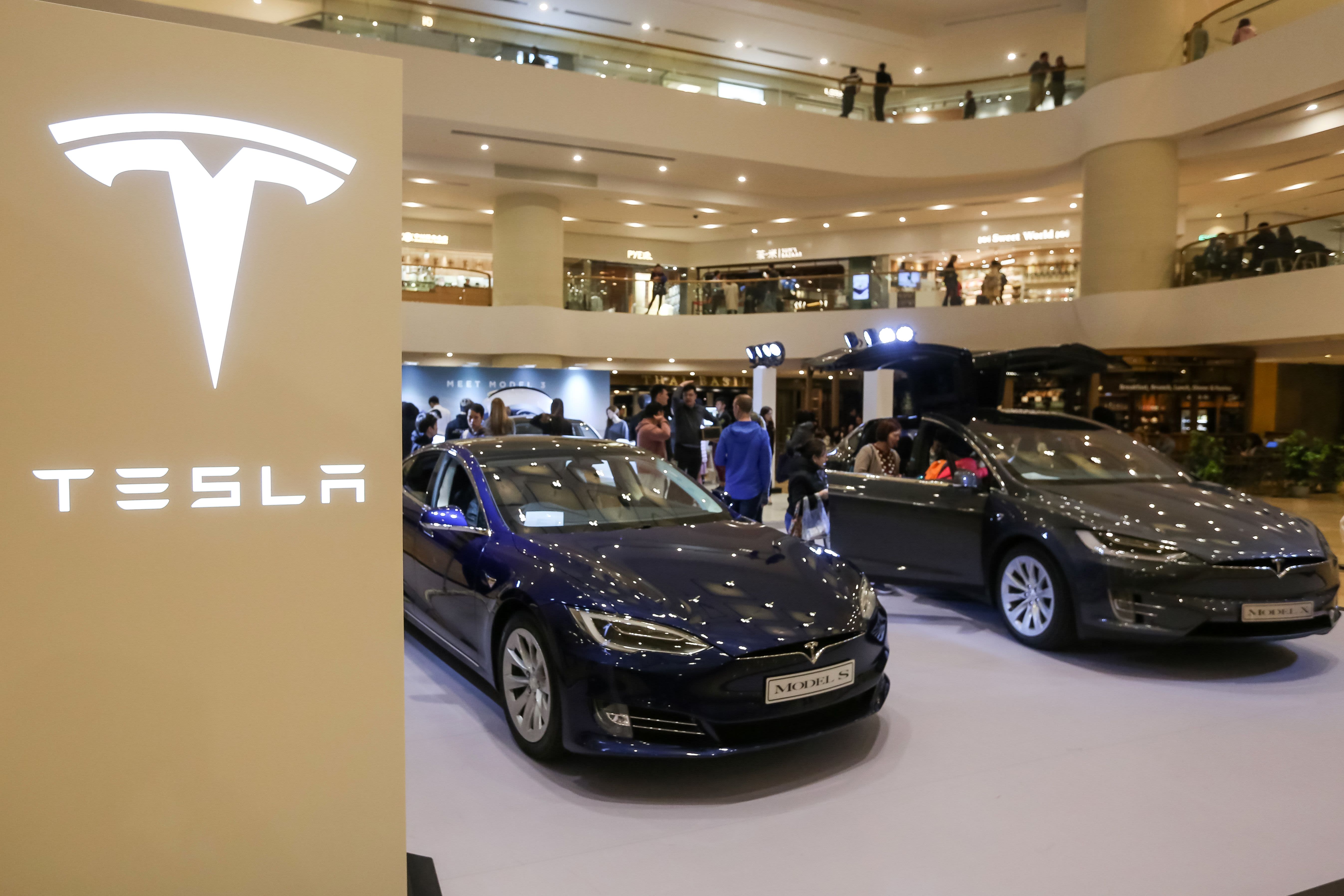 A Tesla Model S (L) and Model X are displayed at a shopping mall in Hong Kong on March 10, 2019.